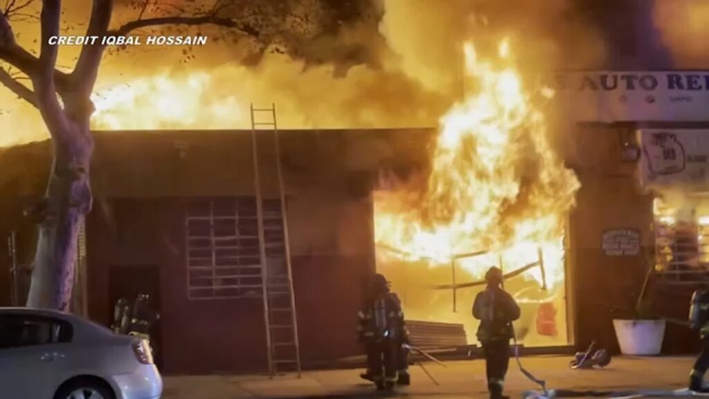 Firefighter injured while battling massive fire at Queens auto repair shop