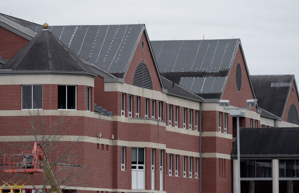 Should the New Milford High School roof be replaced or retested?